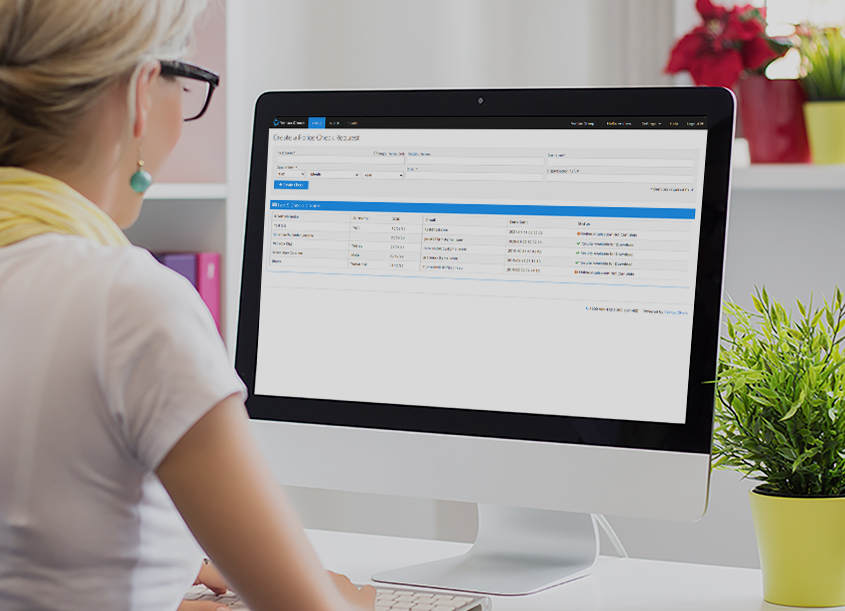 Lady looking at a computer screen displaying company accounts